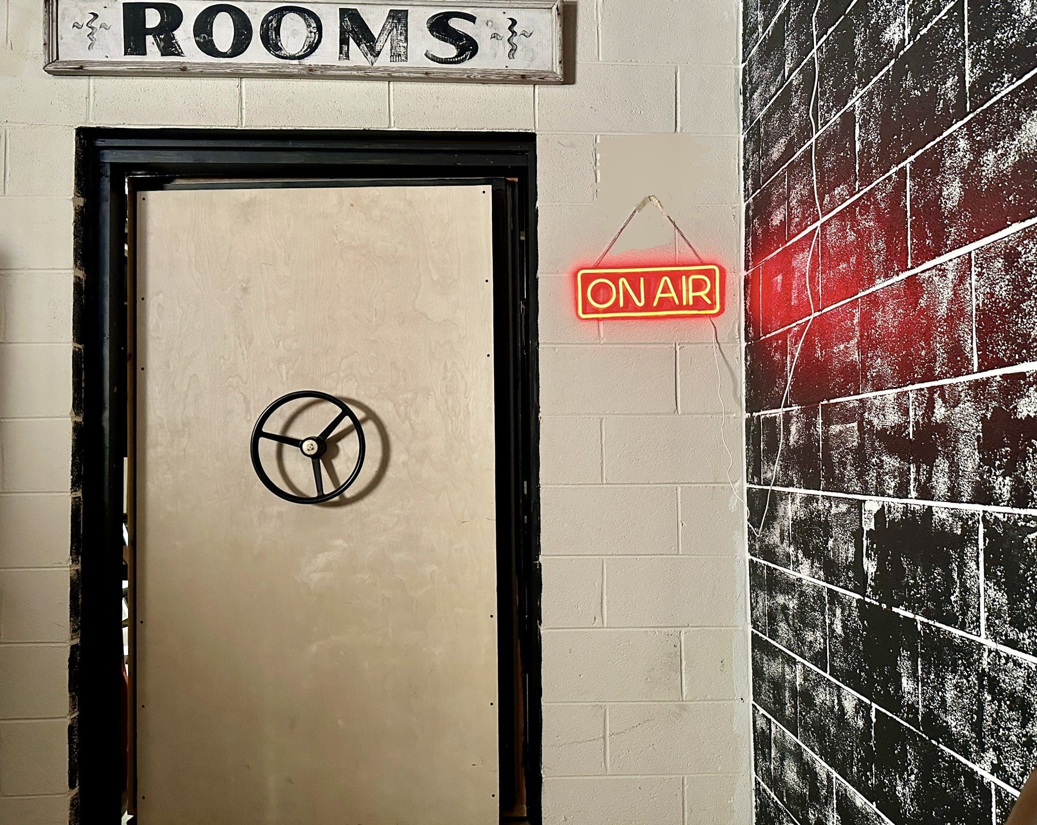 A room with a door and a sign on the wall