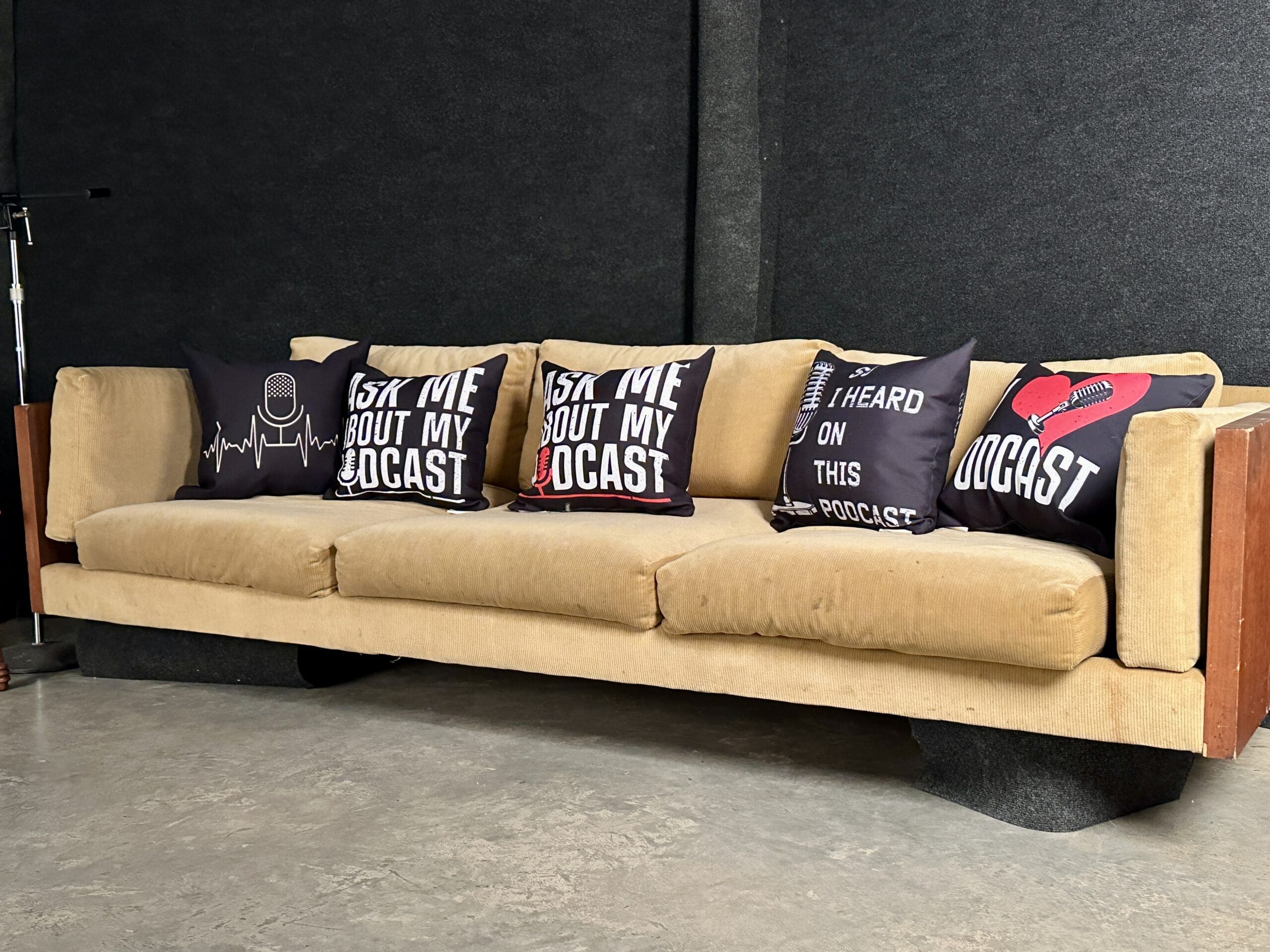 A couch with pillows on it sitting in a room.