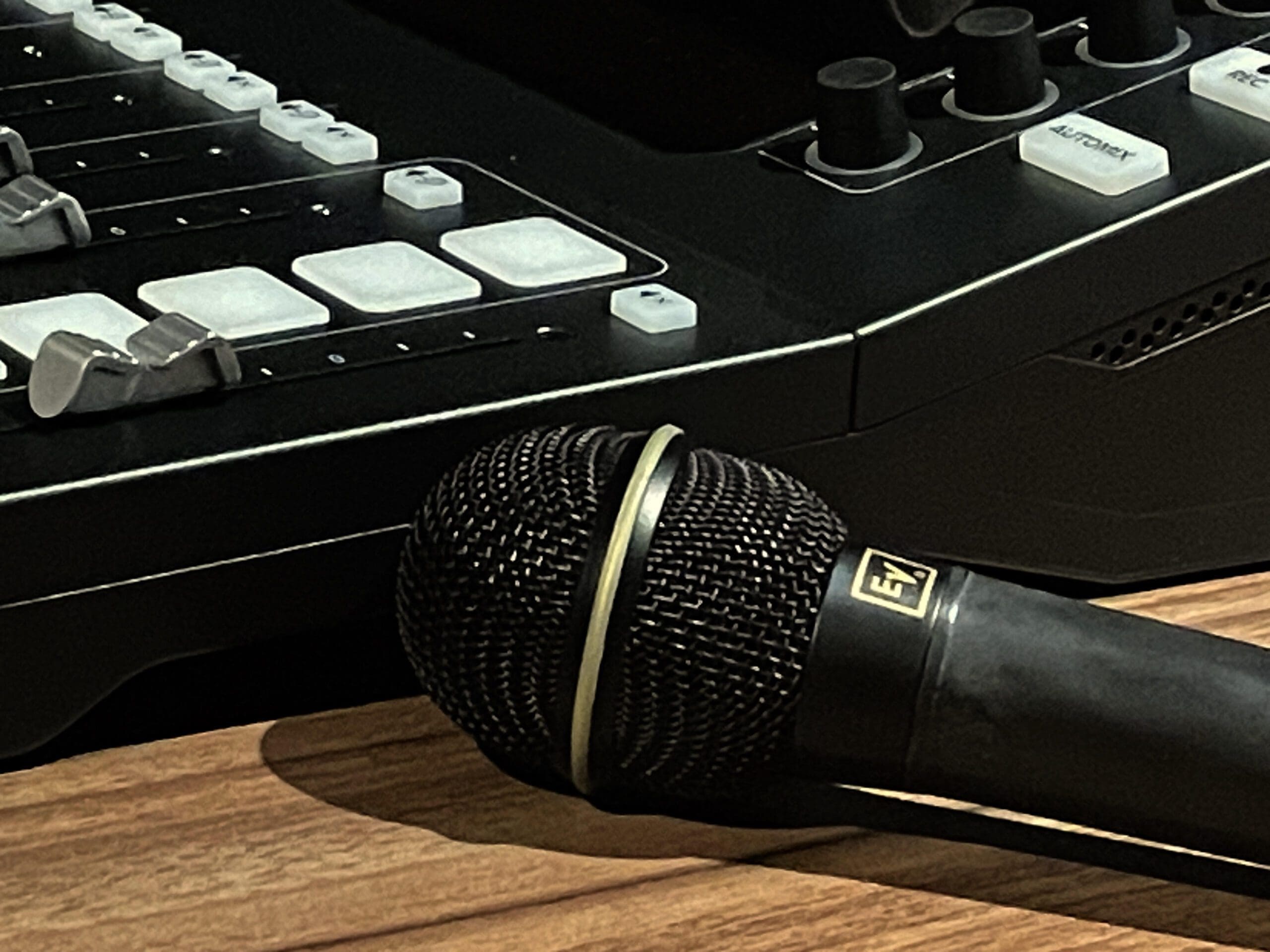A microphone sitting on top of a wooden table.